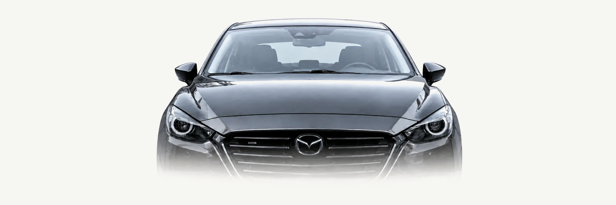 Front view of a Meteor Grey third-generation Mazda3 fading softly into the page background