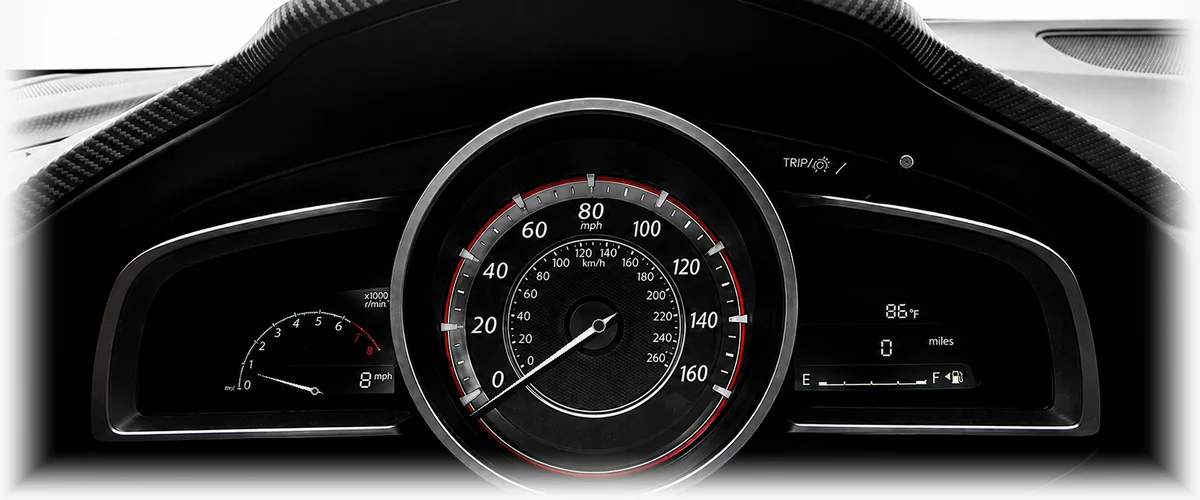 Animated Mazda instrument cluster illustrating acceleration to 60 mph with a first-to-second gear change.