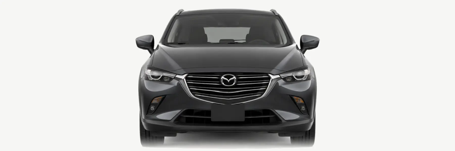 Front view of a graphite Mazda CX-3 DK fading into the page background